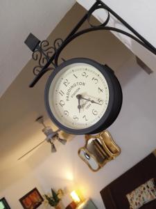 a clock hanging from the ceiling in a room at La Toscana - Actum in San Miguel de Tucumán