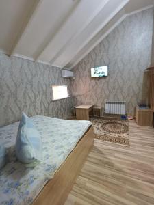 a bedroom with a bed in a room at Ровный in Almaty