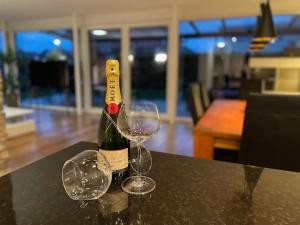 a bottle of wine and two glasses on a table at Alpine Haven Hideaway in Koblach