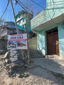 a sign in front of a house with a home stay at Aarav Homestay in Kalpa