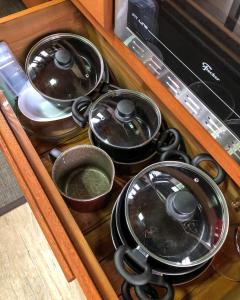 a drawer full of pots and pans in a kitchen at Chalés Altos Da Montanha - Mont Blanc in Bom Jardim da Serra
