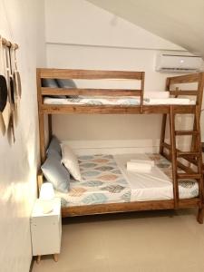a small room with bunk beds in it at Elisha's Guest House in Coron