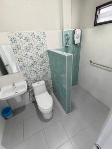 a bathroom with a toilet and a shower and a sink at ลีลาโคซี่ รีสอร์ท ณ สิชล in Sichon