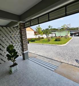 a view from the porch of a house with a potted plant at ลีลาโคซี่ รีสอร์ท ณ สิชล in Sichon