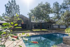 an exterior view of a house with a swimming pool at Upmarket 4 bed Chisipite house - 2193 in Kingsmead