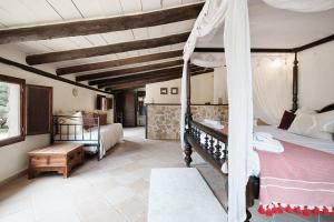 a bedroom with a bunk bed and a room with a bed sqor at Villa Can Ros in Capdellá