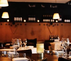 a table in a restaurant with wine glasses on it at Le Virage bistro en hotel in Maastricht