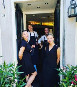 a group of people wearing aprons standing in a doorway at Le Virage bistro en hotel in Maastricht