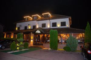 a building with lights on top of it at night at Hotel Dvor in Bijelo Polje
