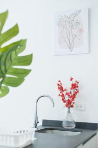 a kitchen sink with a vase with flowers in it at Mountain View Retreat at Khaoyai in Ban Huai Sok Noi