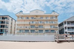 a large building on the beach next to some buildings at Oceans Pointe 402 in Ocean City