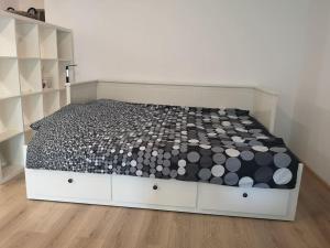 a bedroom with a bed with a black and white comforter at Lovely one bedroom condo next Mall Vitan in Bucharest