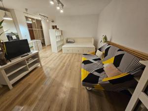 a living room with a couch and a tv at Lovely one bedroom condo next Mall Vitan in Bucharest