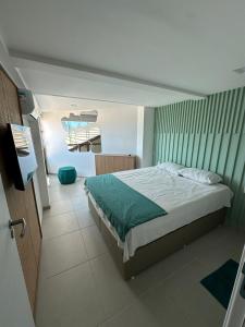 a bedroom with a bed and a television in it at SUNNY HALL, FLAT COM TRÊS QUARTOS in Porto De Galinhas