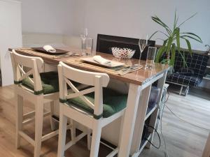 a dining room table with two chairs and a table with wine glasses at Lovely one bedroom condo next Mall Vitan in Bucharest +13 photos
