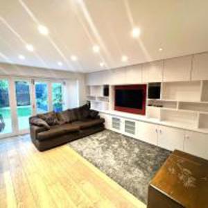 a large living room with a couch and a television at Inviting 4-Bed House in Finchley London in Hendon