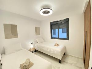 a room with two beds and a window at Paseo De La Playa in Torrevieja +21 photos