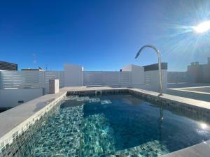 a swimming pool on the roof of a building at Paseo De La Playa in Torrevieja