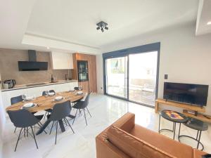 a living room with a large wooden table and chairs at Paseo De La Playa in Torrevieja