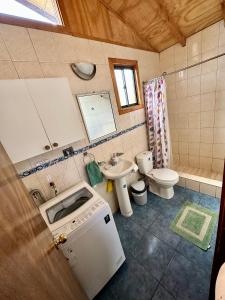 a small bathroom with a sink and a toilet at Cabañas Sra. Flor in Villarrica