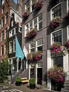 a building with flower boxes on the side of it at Max Brown Hotel Canal District, part of Sircle Collection in Amsterdam