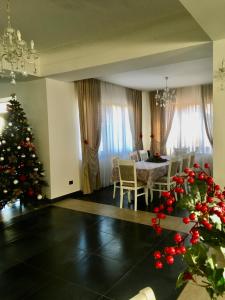 a living room with a christmas tree and a table at Four S Palace in Băile Borşa