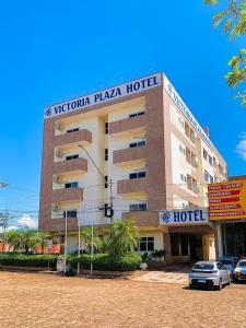 a hotel with a sign on top of it at Victoria Plaza Hotel in Palmas