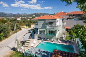 an aerial view of a house with a swimming pool at Hotel Discovery Thassos in Limenaria
