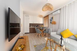 a living room with a couch and a table at Modern Apartment with the River View in Wrocław