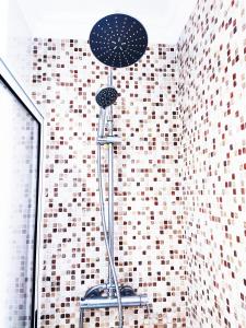 a stand up shower in a bathroom with a tiled wall at Apartment near Expo of Lisboa in Lisbon