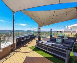 a patio with a couch and chairs on a roof at Ace Location walk to Sun Arena & Menlyn CBD WiFi Self Catering in Pretoria