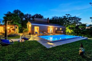a house with a swimming pool in the yard at Villa Ferlini in Central Istria with private 10000 m2 Garden in Svetvinčenat