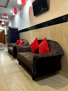 a living room with a couch and a tv at Hotel The Safari in Zirakpur