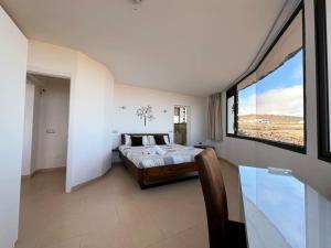 a bedroom with a bed and a large window at Villa with views and Villaverde in Villaverde