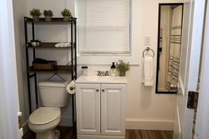 a bathroom with a toilet and a sink at Cozy Atl Getaway - 5 Min From Airport & Downtown in Atlanta