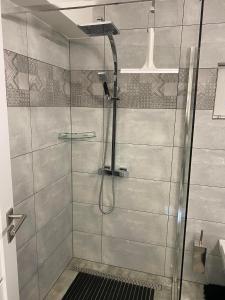 a shower with a glass door in a bathroom at Sportbar 