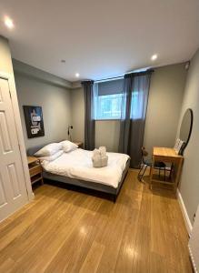 a bedroom with a bed and a table and a window at Union Terrace Garden View in Aberdeen