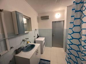 a bathroom with a sink and a toilet at Apartman DALT in Trebinje