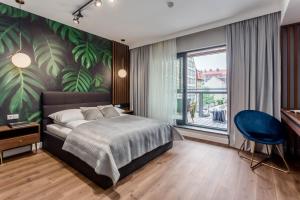 a bedroom with a large bed and a large window at DEO PLAZA - Apartments at the Old Town in Gdańsk