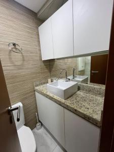 a bathroom with a sink and a toilet at Makambira 307 in Porto De Galinhas