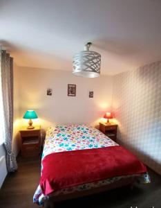 a bedroom with a bed with a red blanket and two lamps at Appartement de 2 chambres avec terrasse amenagee et wifi a Mittlach in Mittlach