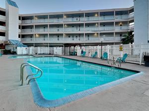 a large swimming pool in front of a hotel at Villa Del Sol 1145 - Mermaids Hideaway in Corpus Christi