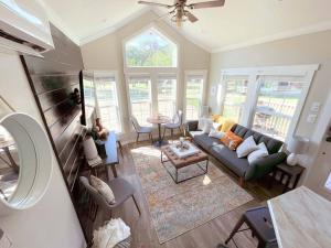 a living room with a couch and a table at Pet friendly Tiny House Rental with new Access to Guadalupe River NBTX in New Braunfels