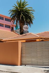 a garage door in front of a building with a palm tree at The City Club On Plein in Cape Town