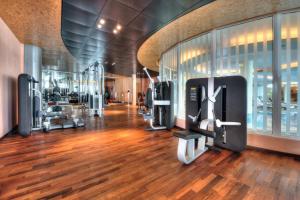 a gym with cardio equipment in a building at Panorama Resort & Spa in Feusisberg