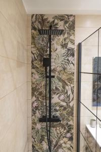 a shower in a bathroom with a floral wallpaper at Stellas Village House in Myrtia
