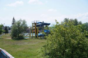 a playground with a slide in a field at Вилно селище "Свети Никола" - язовир Огоста, Монтана - рибари, приятели, гости 0988 продължи 70продължи 9990 in Montana