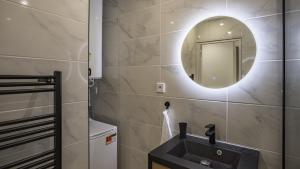 a bathroom with a sink and a mirror at Coeur de Bar - Pour Un Séjour Pétillant in Bar-sur-Aube +17 photos