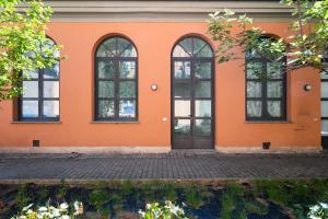 an orange building with windows and a door at Bigattera trilocali - Affitti Brevi Italia in Varese