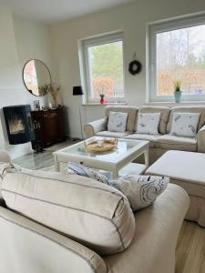 a living room with couches and a table at Mulberry House in Gdańsk